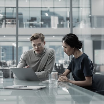 Man and woman at laptop.